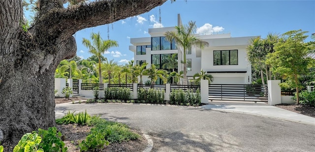 1610 N Lodge Dr, Sarasota, FL 34239 - modern home featuring a fenced front yard, stucco siding, a gate, and driveway