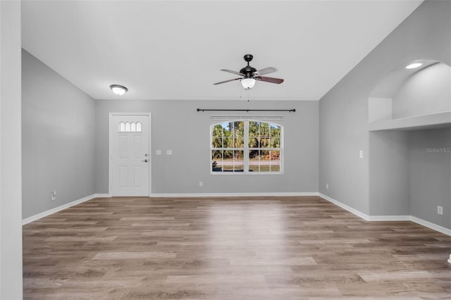 2405 Mistleto Ln, North Port, FL 34286 - unfurnished living room with ceiling fan, vaulted ceiling, and wood finished floors