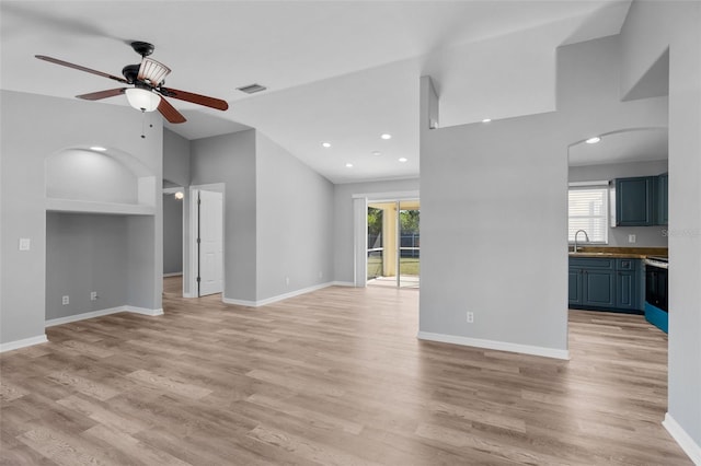 2405 Mistleto Ln, North Port, FL 34286 - unfurnished living room with a ceiling fan, plenty of natural light, light wood finished floors, lofted ceiling, and recessed lighting