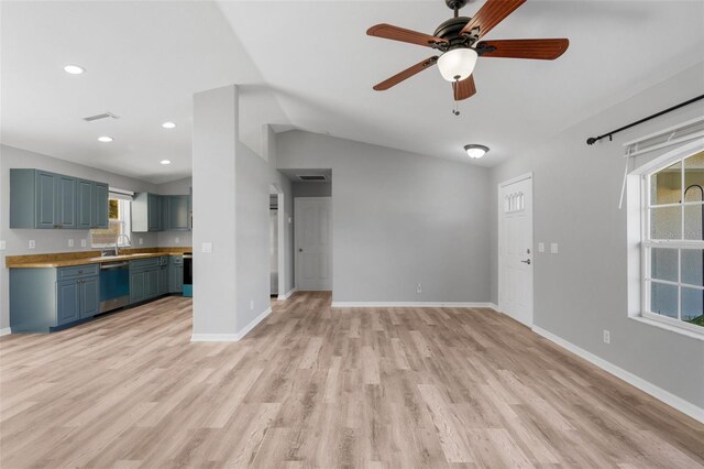 2405 Mistleto Ln, North Port, FL 34286 - unfurnished living room featuring light wood-type flooring, a ceiling fan, lofted ceiling, and recessed lighting