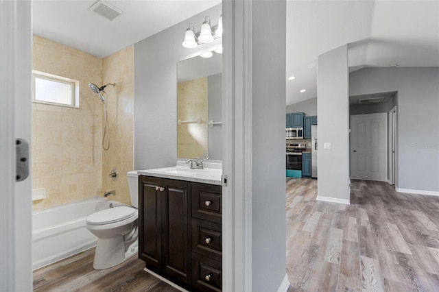 2405 Mistleto Ln, North Port, FL 34286 - bathroom featuring bathtub / shower combination, vanity, wood finished floors, and vaulted ceiling