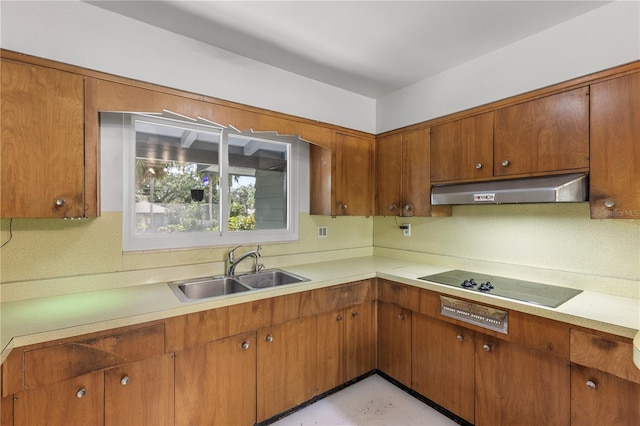 2850 Bon Air Ave, Sarasota, FL 34234 - kitchen featuring under cabinet range hood, black electric cooktop, and light countertops