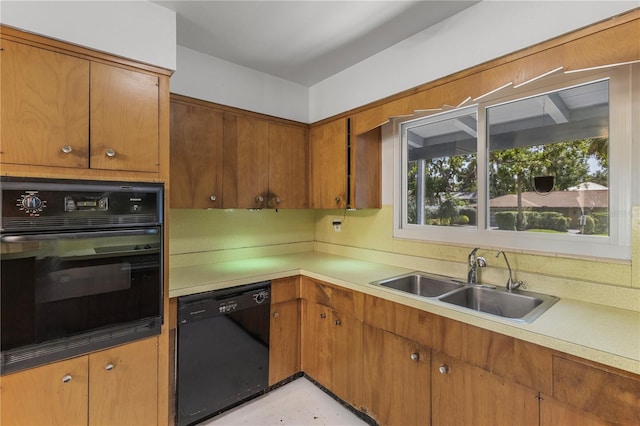 2850 Bon Air Ave, Sarasota, FL 34234 - kitchen featuring black appliances, light countertops, and brown cabinets