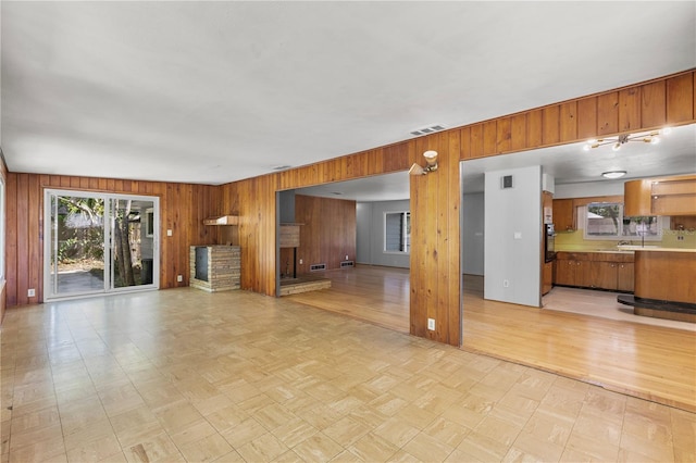 2850 Bon Air Ave, Sarasota, FL 34234 - unfurnished living room with wooden walls and light flooring