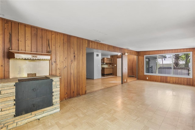 2850 Bon Air Ave, Sarasota, FL 34234 - unfurnished living room featuring wood walls