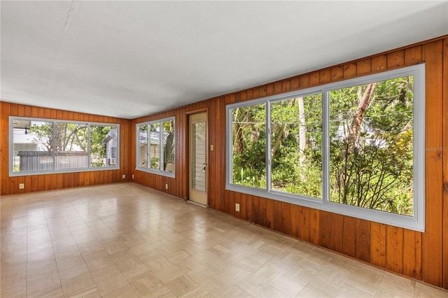 2850 Bon Air Ave, Sarasota, FL 34234 - unfurnished sunroom featuring tile patterned floors and wooden walls