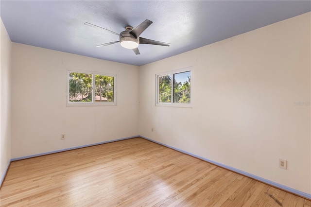 2850 Bon Air Ave, Sarasota, FL 34234 - unfurnished room with light wood finished floors, healthy amount of natural light, and ceiling fan