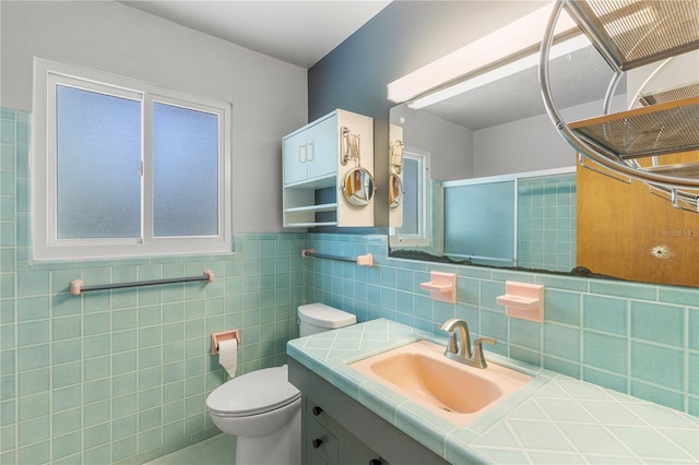 2850 Bon Air Ave, Sarasota, FL 34234 - bathroom with vanity, tile walls, a shower with door, and a wainscoted wall
