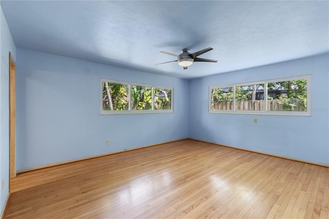 2850 Bon Air Ave, Sarasota, FL 34234 - spare room featuring a ceiling fan, hardwood / wood-style floors, and a textured ceiling
