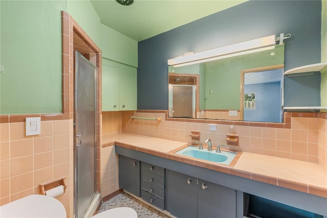 2850 Bon Air Ave, Sarasota, FL 34234 - bathroom featuring a stall shower, vanity, tile walls, and wainscoting