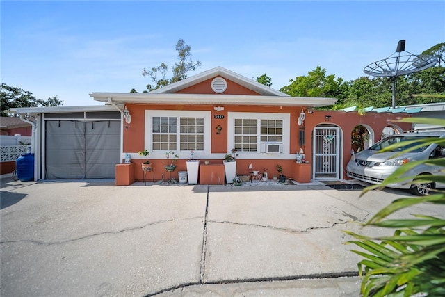 3957 Proctor Rd, Sarasota, FL 34233 - view of front of home with an attached garage, concrete driveway, and stucco siding