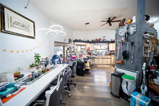 3957 Proctor Rd, Sarasota, FL 34233 - office featuring dark wood-style flooring, a ceiling fan, vaulted ceiling, a chandelier, and a workshop area