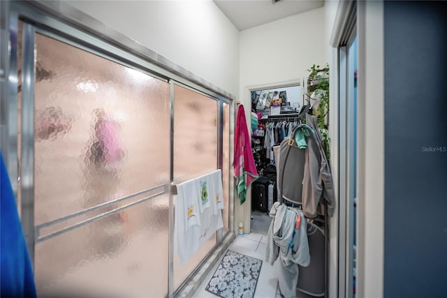 3957 Proctor Rd, Sarasota, FL 34233 - bathroom featuring a shower stall, tile patterned floors, and a spacious closet