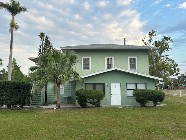 408 3rd Ave E Unit A, B & C, Bradenton, FL 34208 - back of house featuring a lawn and stucco siding
