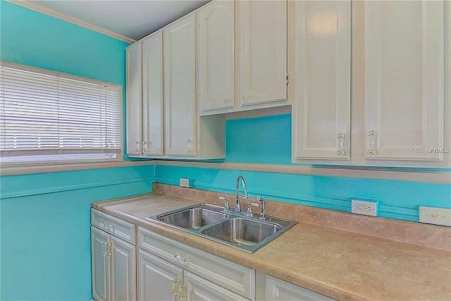 408 3rd Ave E Unit A, B & C, Bradenton, FL 34208 - kitchen featuring light countertops, white cabinetry, and crown molding