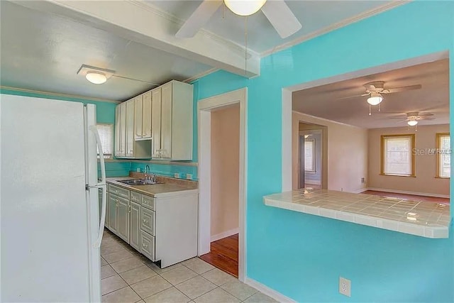 408 3rd Ave E Unit A, B & C, Bradenton, FL 34208 - kitchen with freestanding refrigerator, ceiling fan, light tile patterned floors, crown molding, and tile countertops