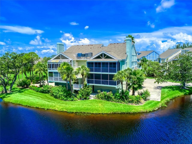 123 Tidy Island Blvd, Bradenton, FL 34210 - rear view of house with a water view, a chimney, and a sunroom