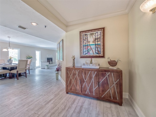 123 Tidy Island Blvd, Bradenton, FL 34210 - corridor featuring light wood-type flooring, a chandelier, and crown molding