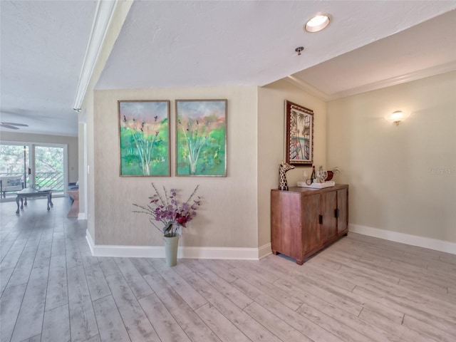 123 Tidy Island Blvd, Bradenton, FL 34210 - hallway with light wood-style floors and ornamental molding