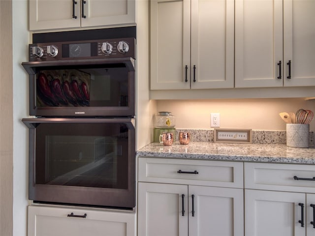 123 Tidy Island Blvd, Bradenton, FL 34210 - kitchen featuring white cabinetry and light stone countertops