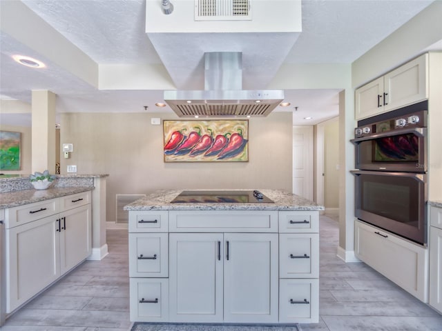 123 Tidy Island Blvd, Bradenton, FL 34210 - kitchen with black electric stovetop, extractor fan, double oven, wood tiled floors, and a kitchen island