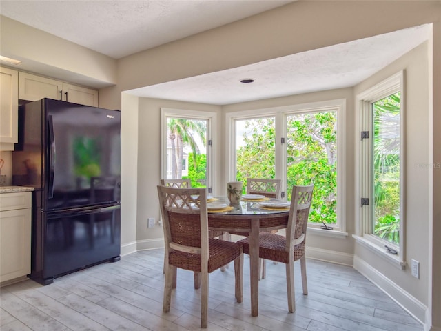 123 Tidy Island Blvd, Bradenton, FL 34210 - dining space featuring light wood-style floors and baseboards