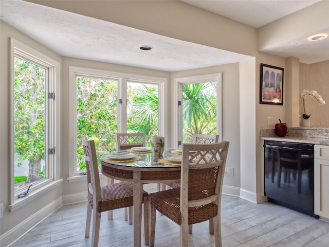 123 Tidy Island Blvd, Bradenton, FL 34210 - dining area featuring bar with sink and wood tiled floors