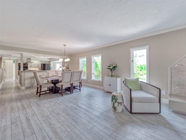 123 Tidy Island Blvd, Bradenton, FL 34210 - dining space with light wood-style flooring, crown molding, and a chandelier