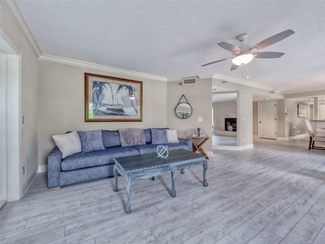 123 Tidy Island Blvd, Bradenton, FL 34210 - living area featuring a ceiling fan, light wood finished floors, and ornamental molding