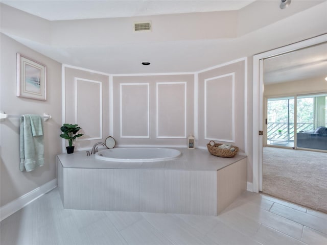 123 Tidy Island Blvd, Bradenton, FL 34210 - bathroom with a bath and tile patterned flooring
