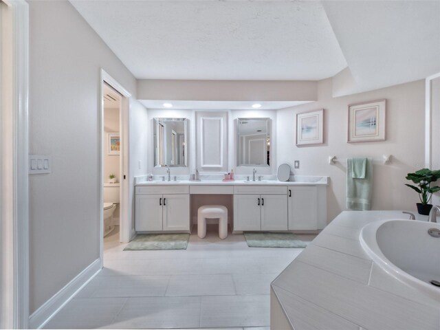 123 Tidy Island Blvd, Bradenton, FL 34210 - full bathroom featuring double vanity, a tub to relax in, and tile patterned flooring