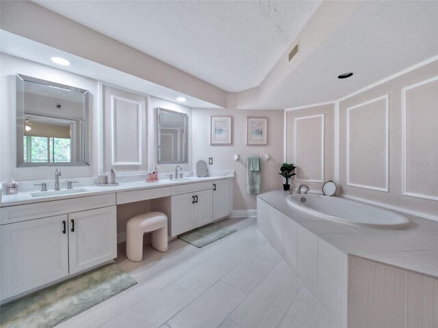 123 Tidy Island Blvd, Bradenton, FL 34210 - bathroom featuring double vanity, a garden tub, and recessed lighting
