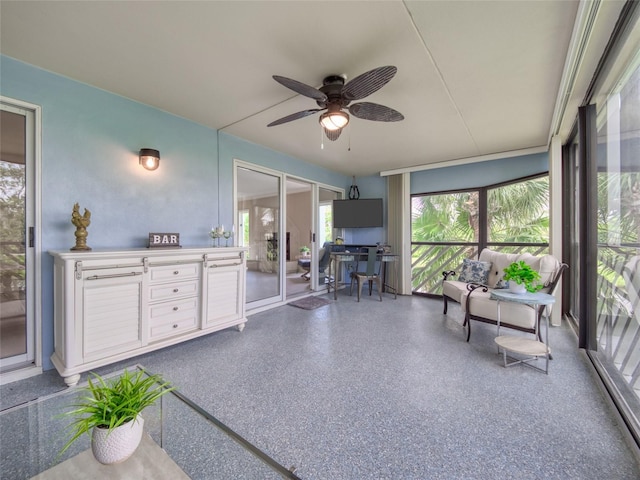 123 Tidy Island Blvd, Bradenton, FL 34210 - sunroom with a ceiling fan, speckle patterned floor, and an outdoor kitchen