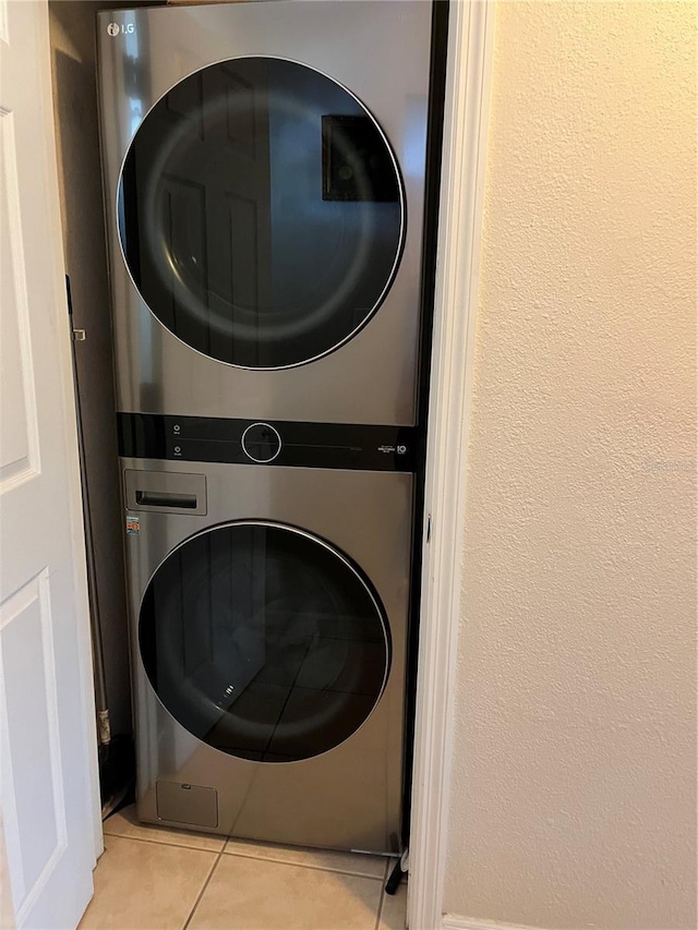 900 La Costa Cir Unit 4, Sarasota, FL 34237 - laundry room with stacked washing machine and dryer and light tile patterned floors