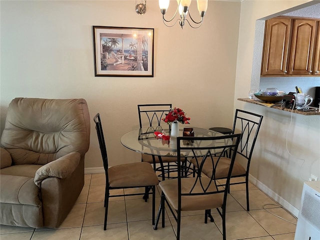 900 La Costa Cir Unit 4, Sarasota, FL 34237 - dining area featuring a chandelier and light tile patterned floors