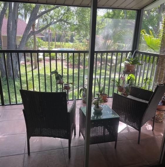 900 La Costa Cir Unit 4, Sarasota, FL 34237 - sunroom with healthy amount of natural light and outdoor lounge area