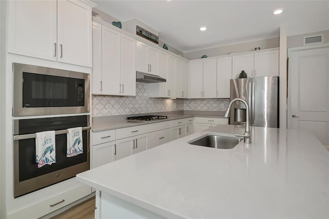 16231 Tradewind Ter, Bradenton, FL 34211 - kitchen featuring appliances with stainless steel finishes, under cabinet range hood, white cabinets, and recessed lighting
