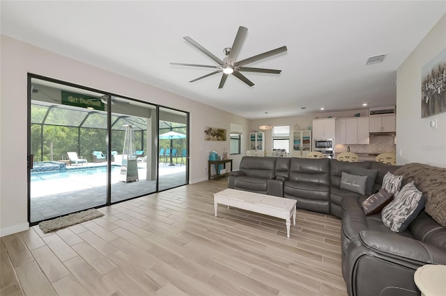 16231 Tradewind Ter, Bradenton, FL 34211 - living room with a ceiling fan, recessed lighting, a sunroom, and light wood finished floors