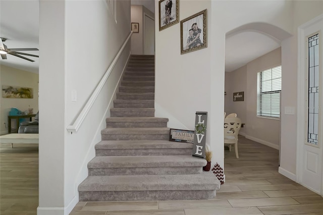 16231 Tradewind Ter, Bradenton, FL 34211 - staircase featuring arched walkways, wood finish floors, and ceiling fan
