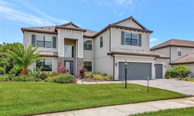 16231 Tradewind Ter, Bradenton, FL 34211 - view of front of home featuring concrete driveway, a garage, a front yard, and stucco siding