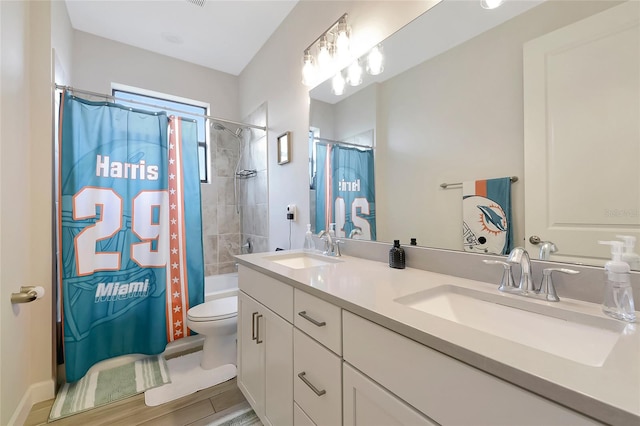 16231 Tradewind Ter, Bradenton, FL 34211 - bathroom featuring double vanity, shower / bath combo with shower curtain, and wood finished floors