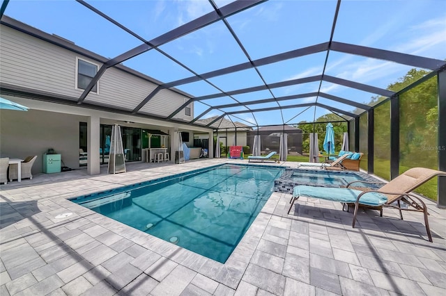 16231 Tradewind Ter, Bradenton, FL 34211 - view of pool featuring a patio, glass enclosure, and a pool with connected hot tub