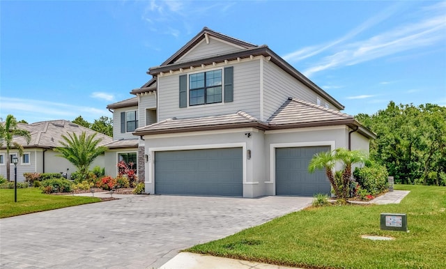 16231 Tradewind Ter, Bradenton, FL 34211 - view of front of home with decorative driveway, a front lawn, a garage, and stucco siding
