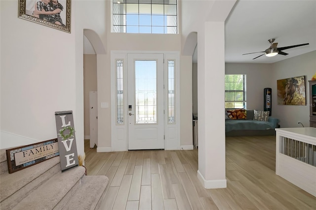 16231 Tradewind Ter, Bradenton, FL 34211 - foyer featuring wood finished floors, arched walkways, and a ceiling fan