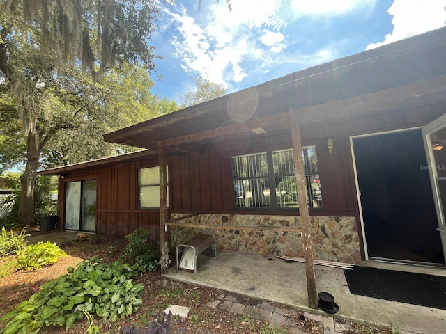 507 Cloudcroft Dr, Deltona, FL 32738 - back of house with board and batten siding and stone siding
