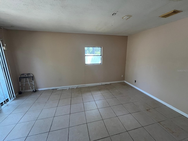 507 Cloudcroft Dr, Deltona, FL 32738 - unfurnished room with light tile patterned flooring and a textured ceiling
