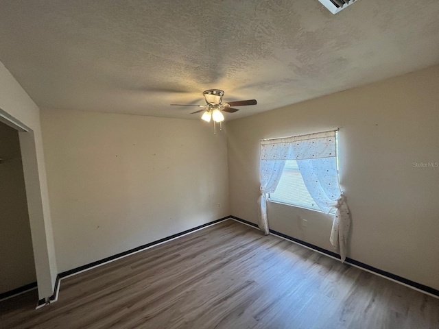 507 Cloudcroft Dr, Deltona, FL 32738 - unfurnished bedroom with wood finished floors, a textured ceiling, and ceiling fan