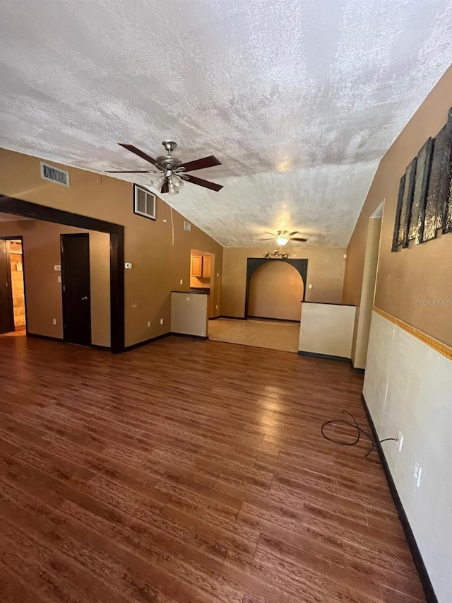 507 Cloudcroft Dr, Deltona, FL 32738 - unfurnished living room featuring ceiling fan, lofted ceiling, a textured ceiling, and wood finished floors