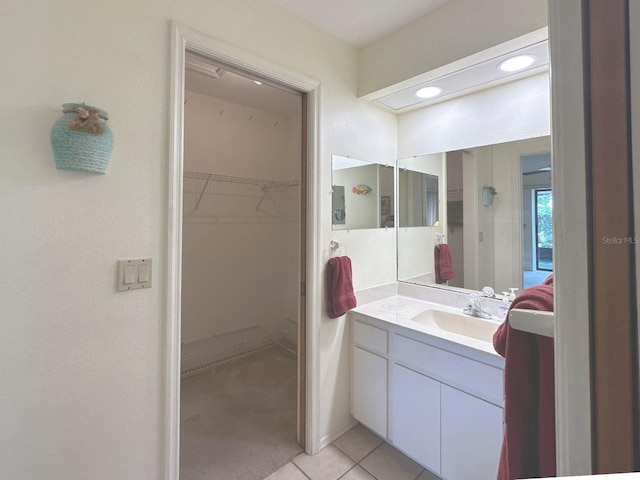 22321 Yonkers Ave, Port Charlotte, FL 33952 - bathroom with vanity, tile patterned flooring, and a walk in closet