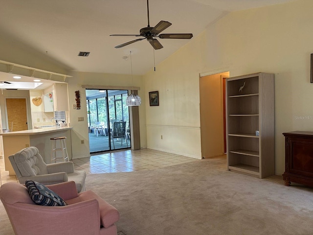 22321 Yonkers Ave, Port Charlotte, FL 33952 - living area featuring ceiling fan, light carpet, light tile patterned flooring, and high vaulted ceiling